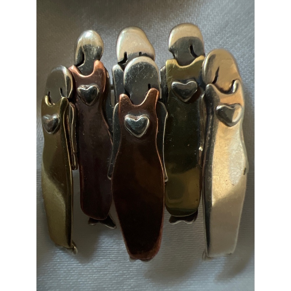 Farfetched mixed metal pin with women and hearts.
